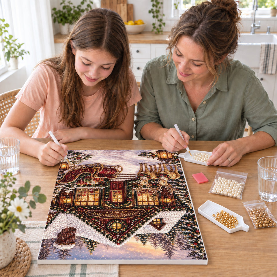 Mother and daughter creating one shared Pearl artwork — Snowy Christmas Shop with Reindeer and Sleigh. Pearl diamond painting DIY kit by Isuvio.
