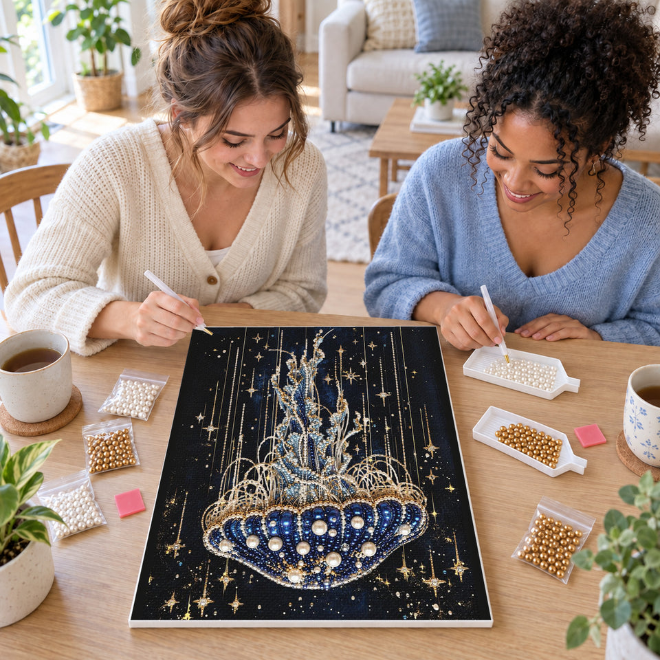 Two friends creating one shared Pearl artwork — Blue Jellyfish Beneath Golden Stars. Pearl diamond painting DIY kit by Isuvio.