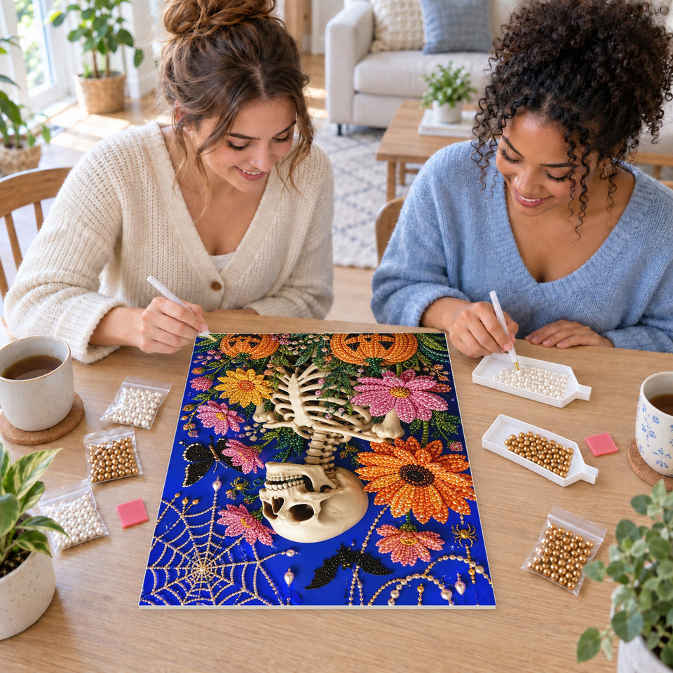 Two friends creating one shared Pearl artwork — Floral Skeleton among Bats and Pumpkins. Pearl diamond painting DIY kit by Isuvio.