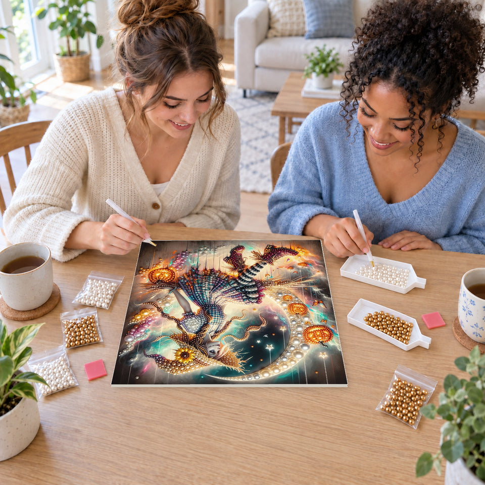 Two friends creating one shared Pearl artwork — Sunflower Witch on a Broom Beneath a Crescent Moon. Pearl diamond painting DIY kit by Isuvio.