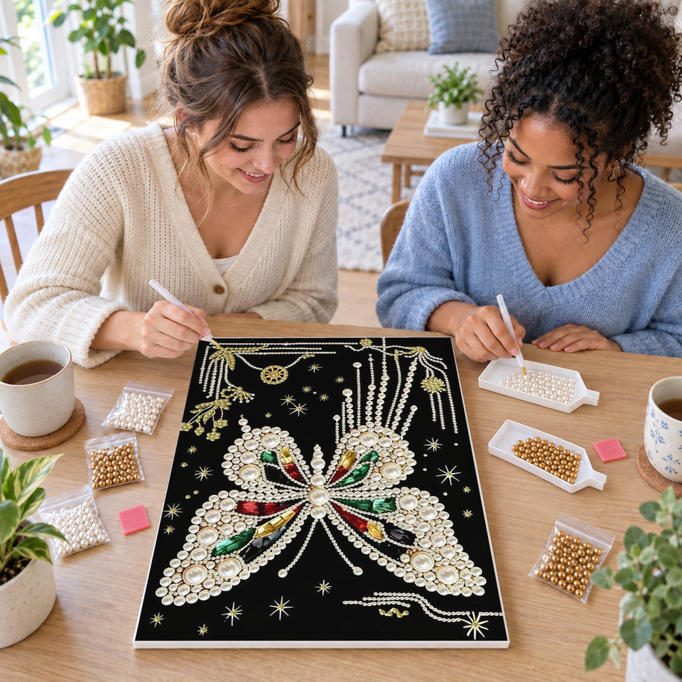 Two friends creating one shared Pearl artwork — White Pearl Butterfly with Colored Gems on Black. Pearl diamond painting DIY kit by Isuvio.