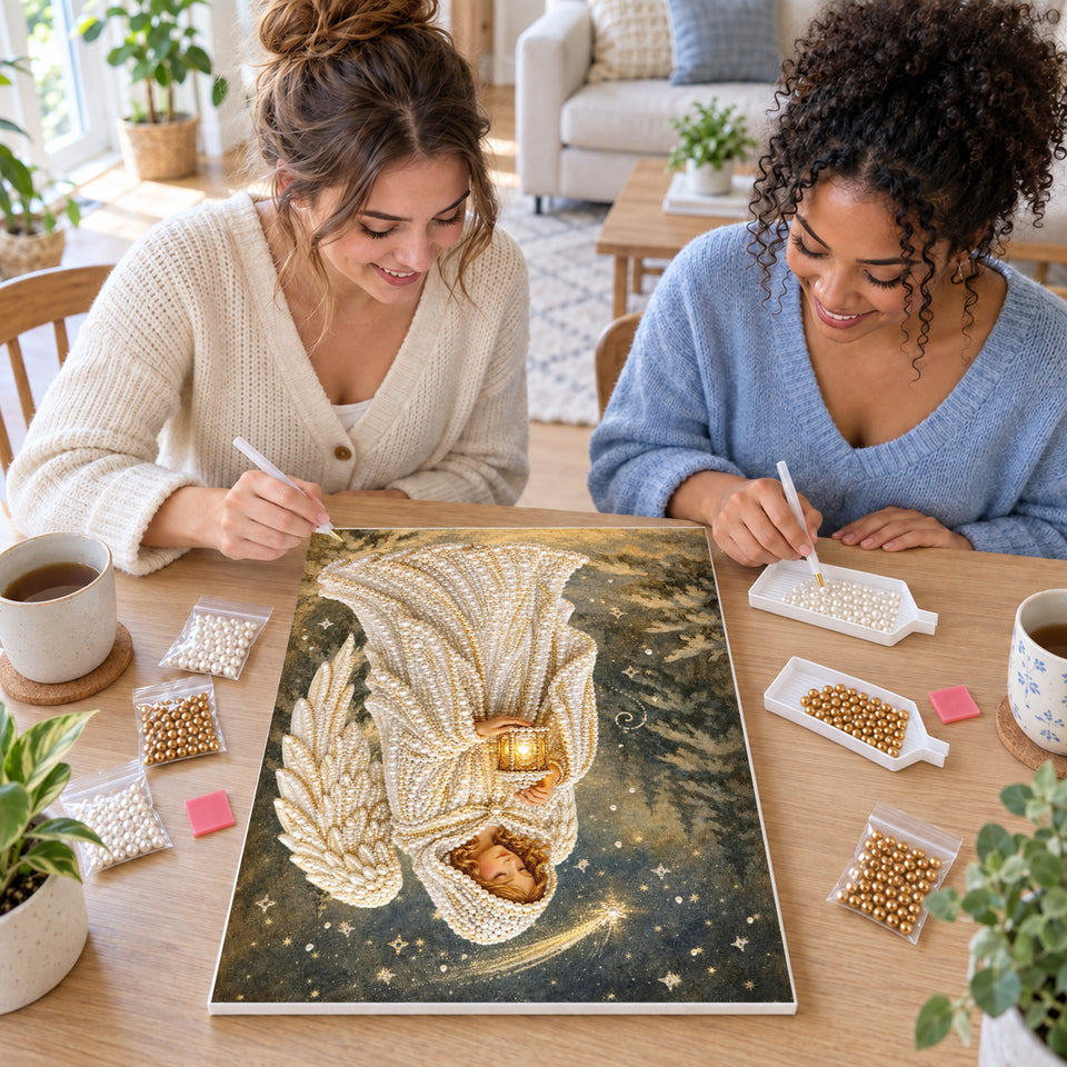 Two friends creating one shared Pearl artwork — Angel with Lantern Under a Shooting Star. Pearl diamond painting DIY kit by Isuvio.