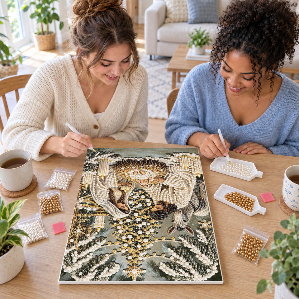 Two friends creating one shared Pearl artwork — Snowy Nativity Beneath the Christmas Tree. Pearl diamond painting DIY kit by Isuvio.