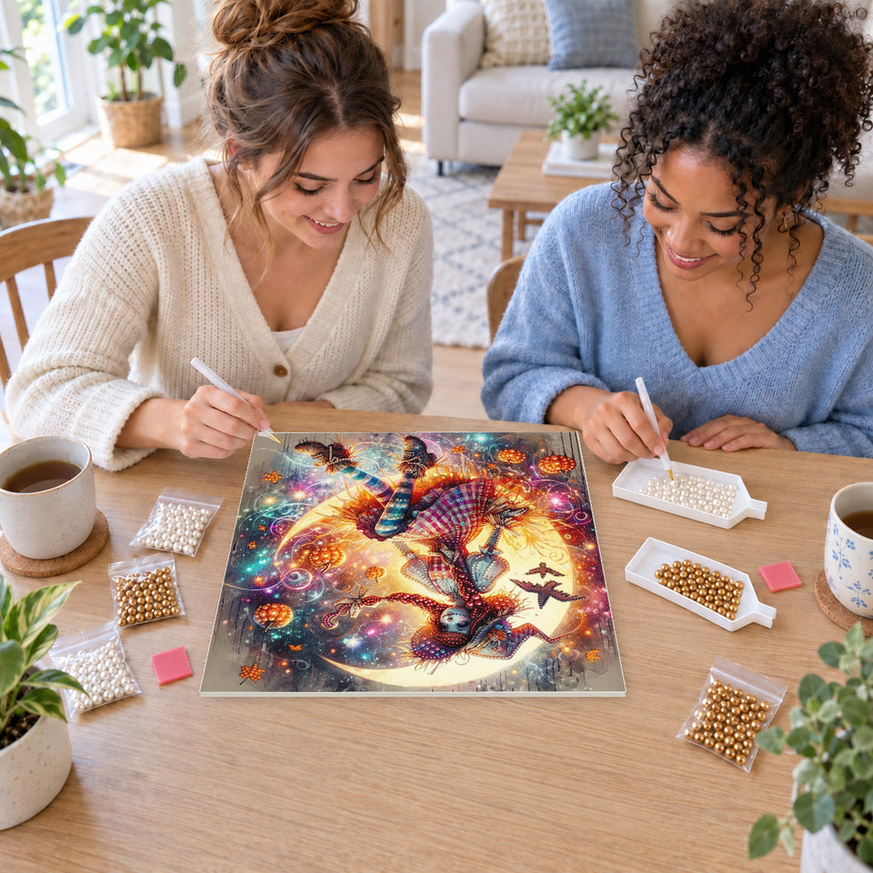 Two friends creating one shared Pearl artwork — Patchwork Witch on a Glowing Crescent Moon. Pearl diamond painting DIY kit by Isuvio.