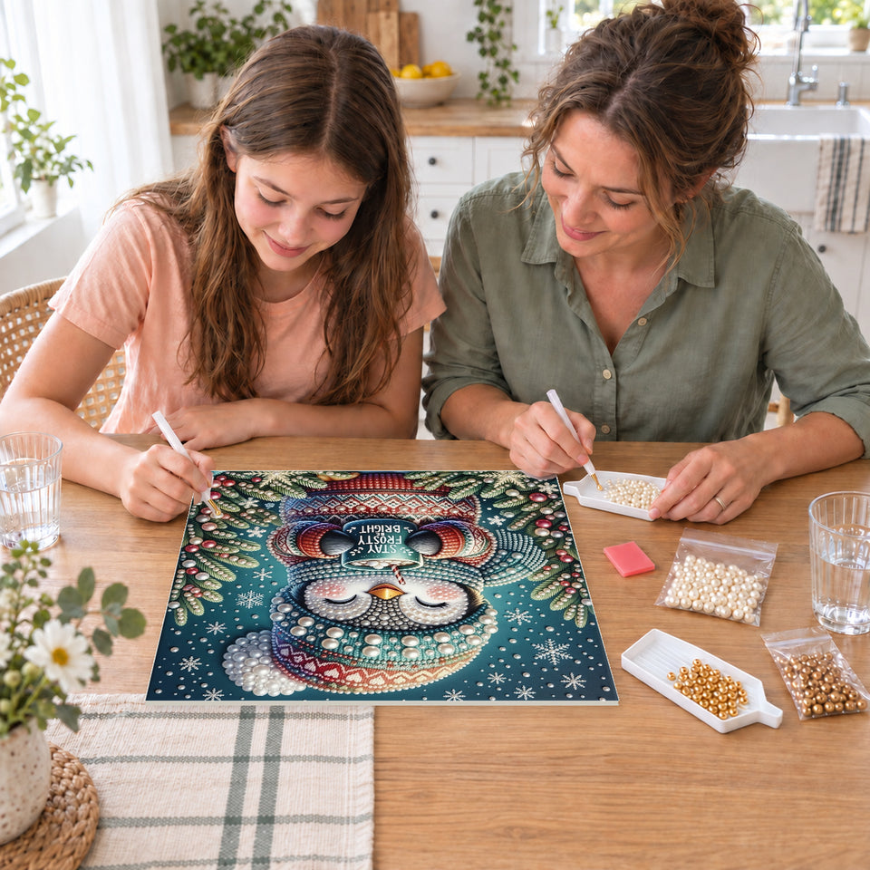 Mother and daughter creating one shared Pearl artwork — Stay Frosty Penguin with a Cocoa Mug. Pearl diamond painting DIY kit by Isuvio.