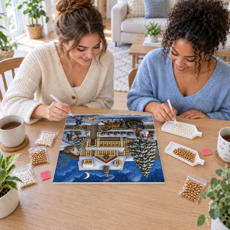 Two friends creating one shared Pearl artwork — Horse-Drawn Sleigh Outside a Snowy Christmas House. Pearl diamond painting DIY kit by Isuvio.