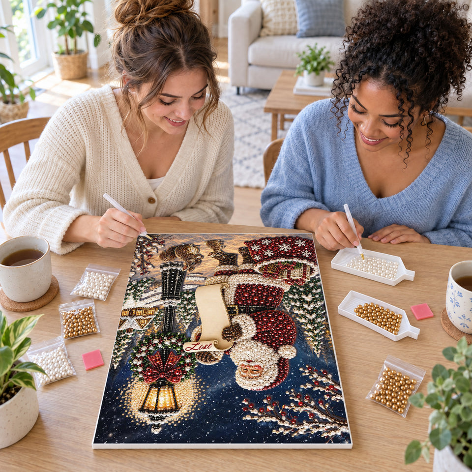 Two friends creating one shared Pearl artwork — Santa and Nice List in Winter Village. Pearl diamond painting DIY kit by Isuvio.