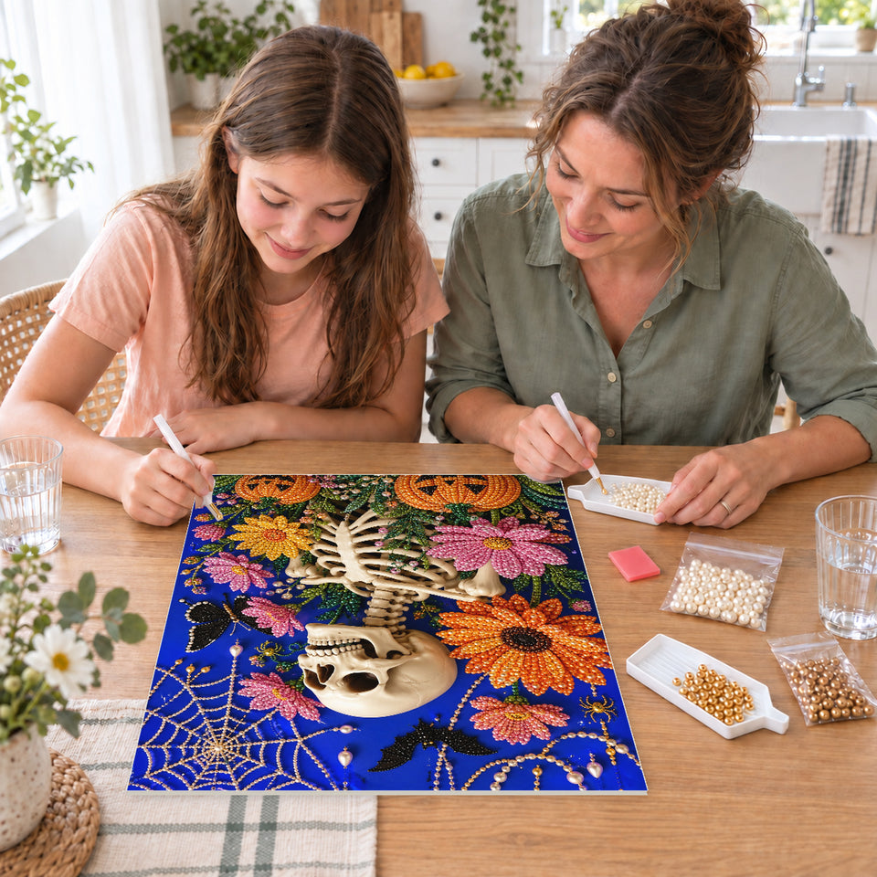 Mother and daughter creating one shared Pearl artwork — Floral Skeleton among Bats and Pumpkins. Pearl diamond painting DIY kit by Isuvio.