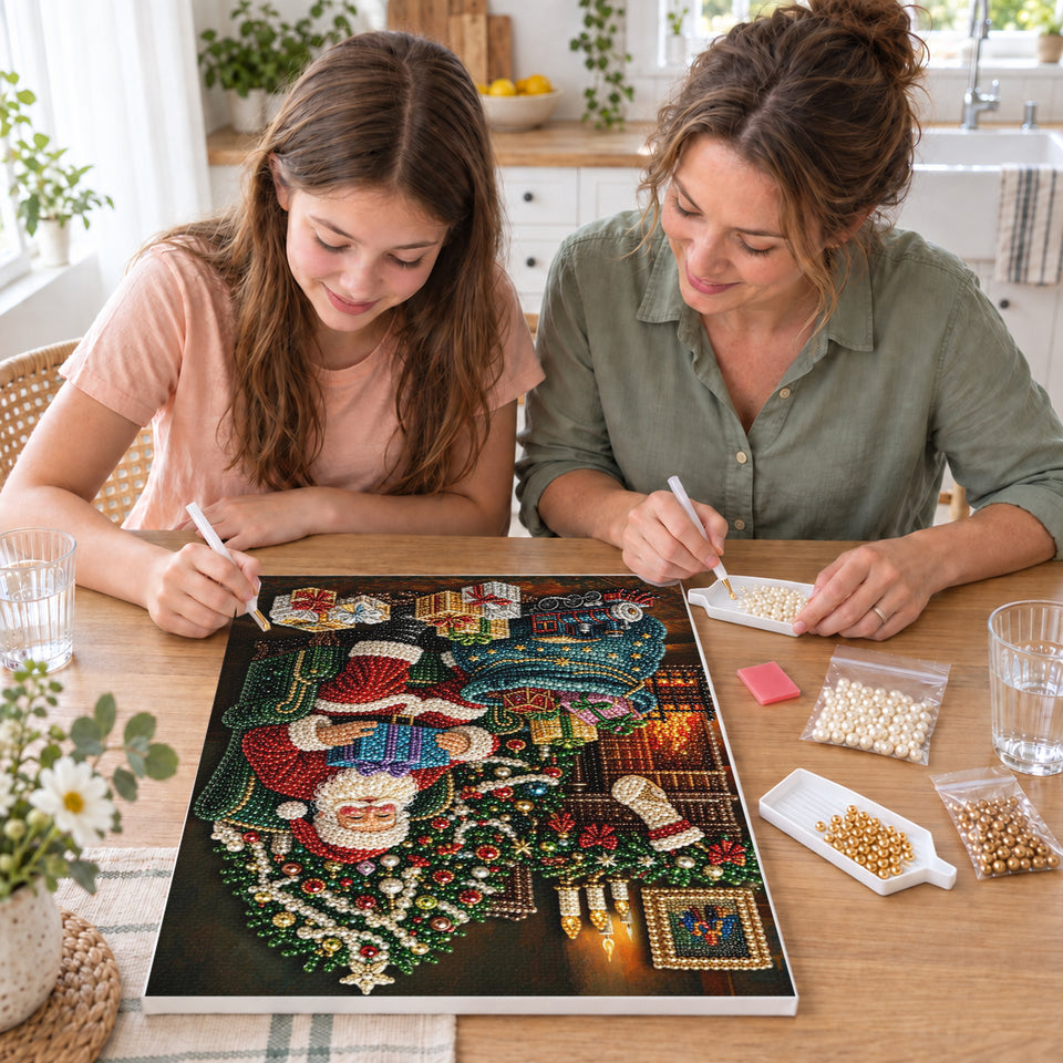 Mother and daughter creating one shared Pearl artwork — Santa by the Christmas Fireplace. Pearl diamond painting DIY kit by Isuvio.
