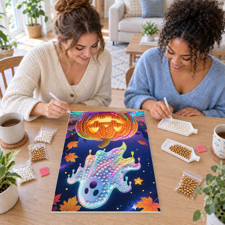 Two friends creating one shared Pearl artwork — Rainbow Pearl Ghost Above a Glowing Pumpkin. Pearl diamond painting DIY kit by Isuvio.