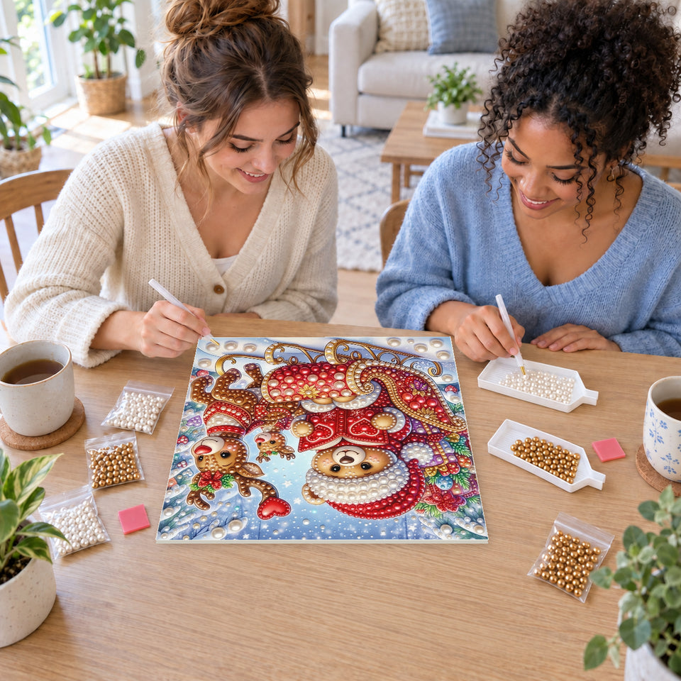 Two friends creating one shared Pearl artwork — Christmas Teddy Bear in a Red Reindeer Sleigh. Pearl diamond painting DIY kit by Isuvio.