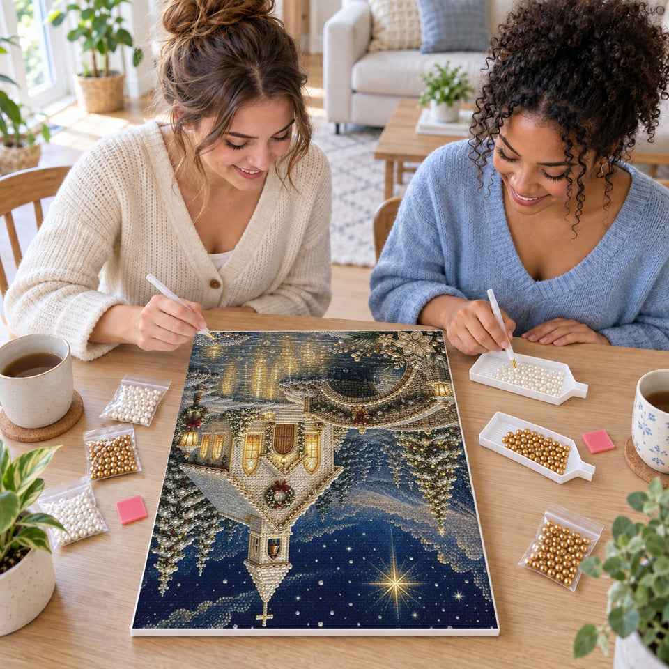 Two friends creating one shared Pearl artwork — Christmas Chapel Beside a Stone Bridge. Pearl diamond painting DIY kit by Isuvio.
