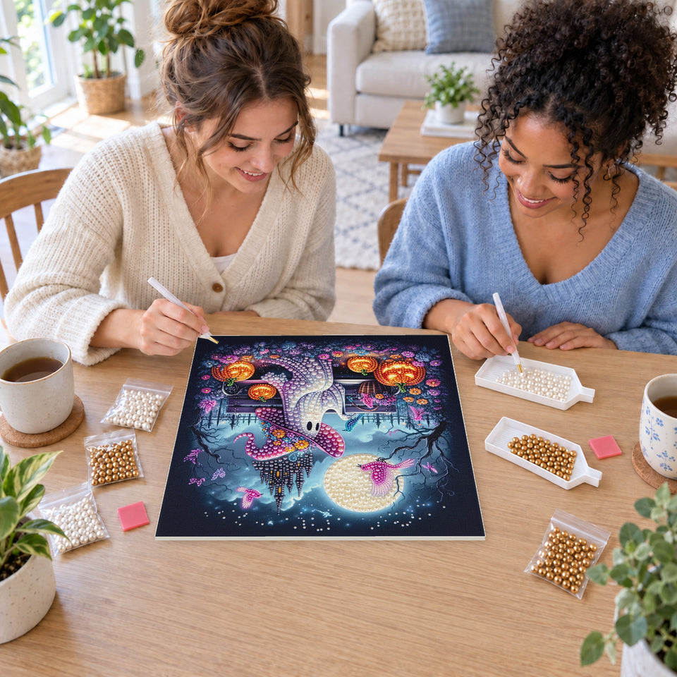 Two friends creating one shared Pearl artwork — Ghost in a Purple Witch Hat by a Moonlit Castle. Pearl diamond painting DIY kit by Isuvio.
