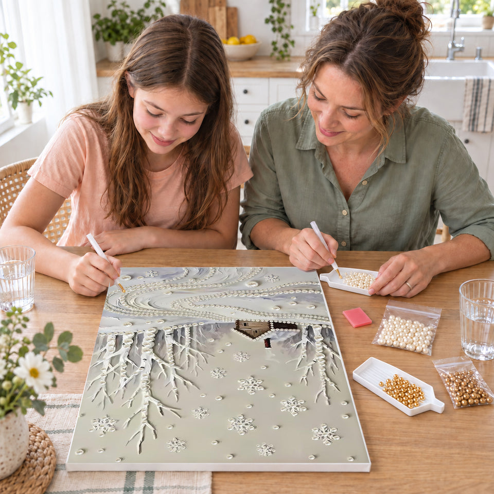 Mother and daughter creating one shared Pearl artwork — Snowy Woodland Cabin and Winding Pearl Path. Pearl diamond painting DIY kit by Isuvio.