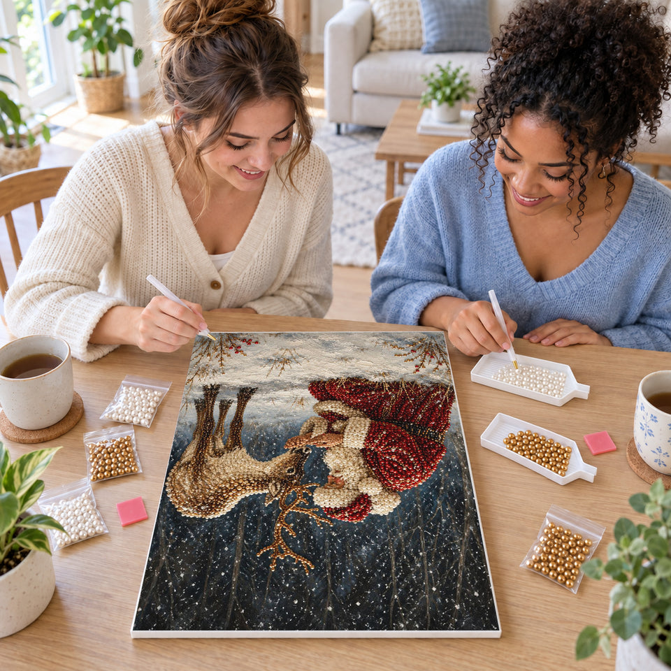 Two friends creating one shared Pearl artwork — Santa Feeding a Reindeer in the Snowy Forest. Pearl diamond painting DIY kit by Isuvio.