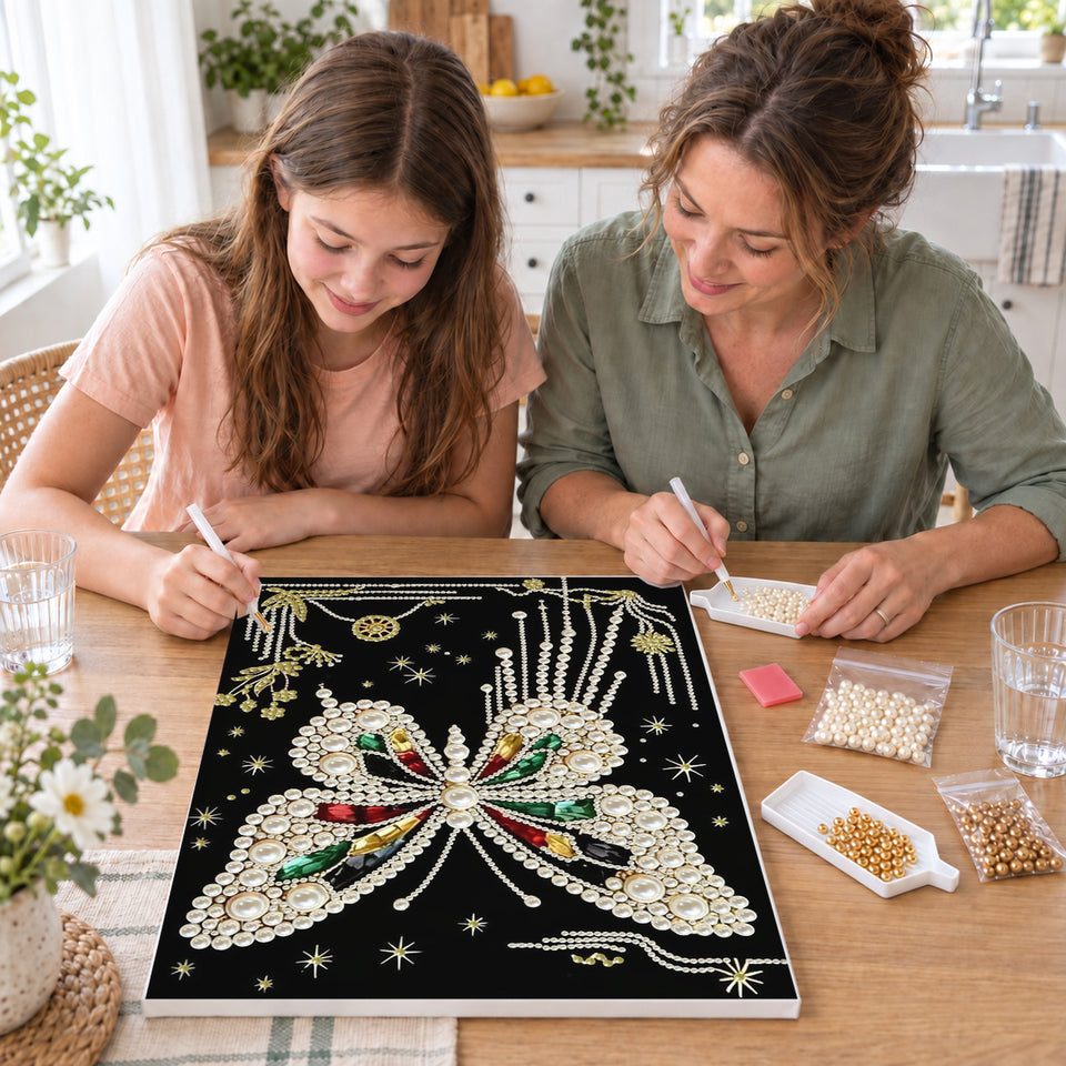 Mother and daughter creating one shared Pearl artwork — White Pearl Butterfly with Colored Gems on Black. Pearl diamond painting DIY kit by Isuvio.