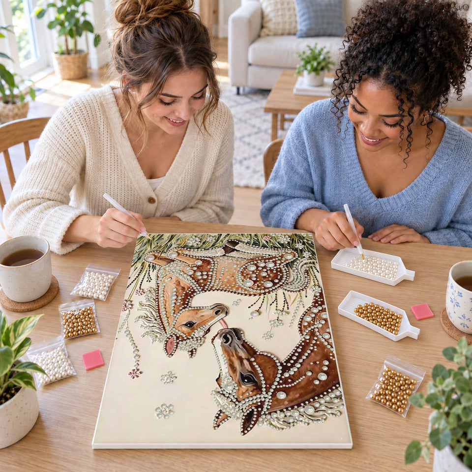 Two friends creating one shared Pearl artwork — Mare and Foal in a Flowering Meadow. Pearl diamond painting DIY kit by Isuvio.
