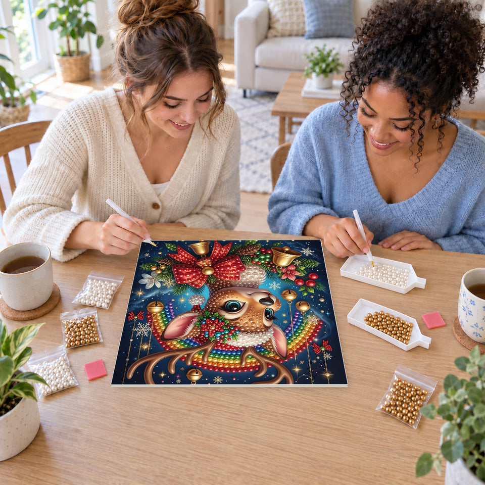 Two friends creating one shared Pearl artwork — Christmas Reindeer with Ornament Antlers. Pearl diamond painting DIY kit by Isuvio.
