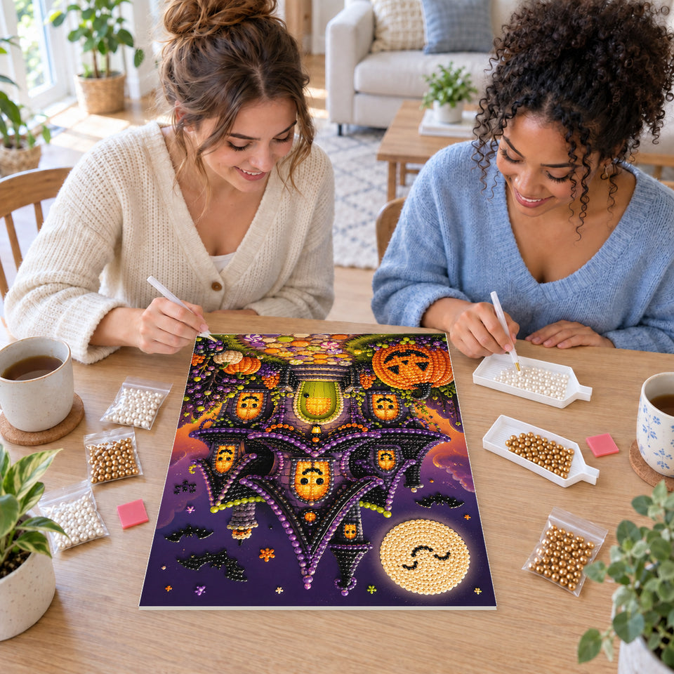 Two friends creating one shared Pearl artwork — Whimsical Haunted House with Glowing Pumpkin Windows. Pearl diamond painting DIY kit by Isuvio.