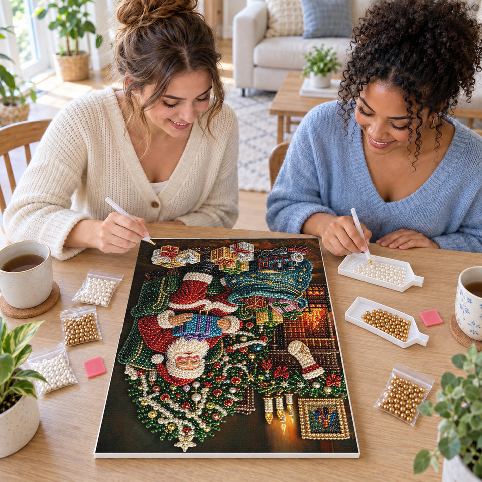 Two friends creating one shared Pearl artwork — Santa by the Christmas Fireplace. Pearl diamond painting DIY kit by Isuvio.