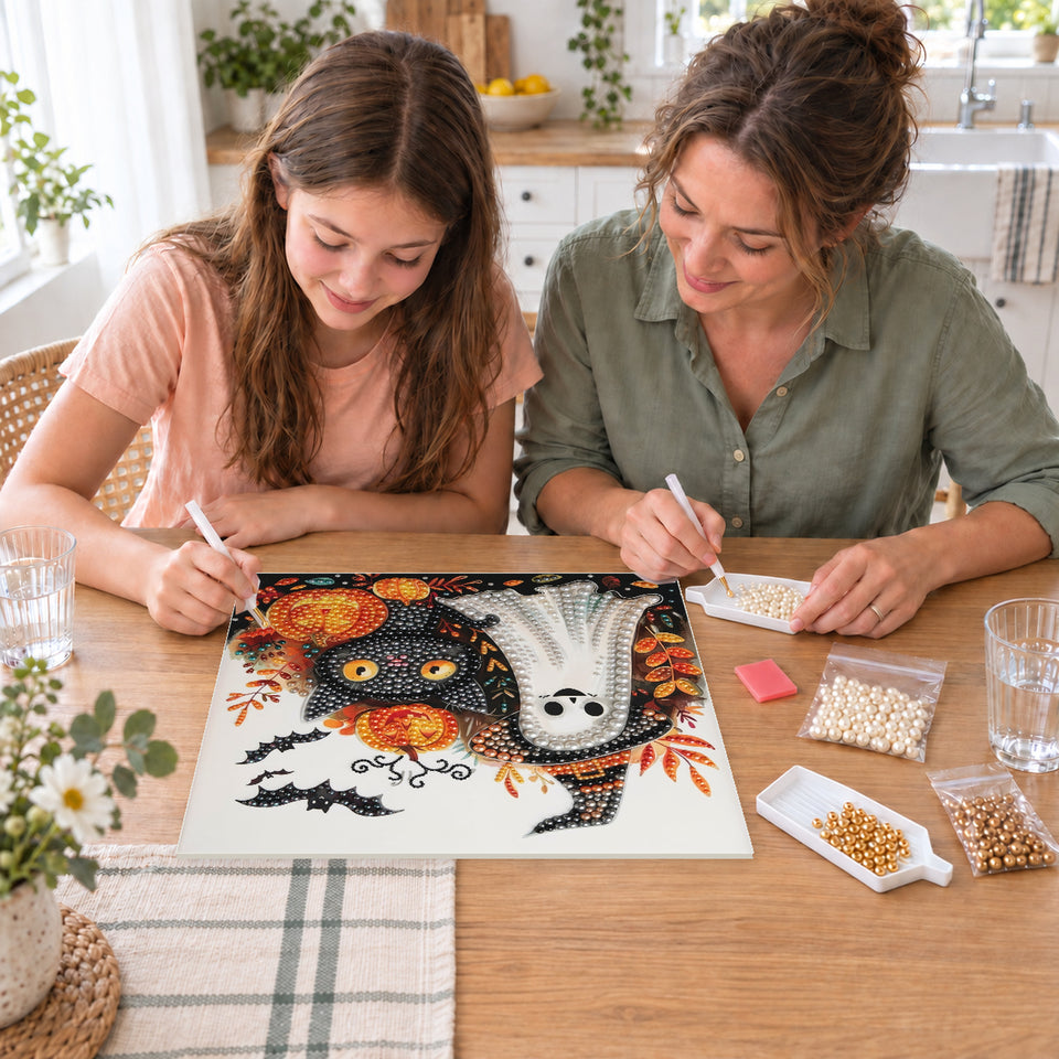 Mother and daughter creating one shared Pearl artwork — Friendly Ghost and Black Cat Among Pumpkins. Pearl diamond painting DIY kit by Isuvio.