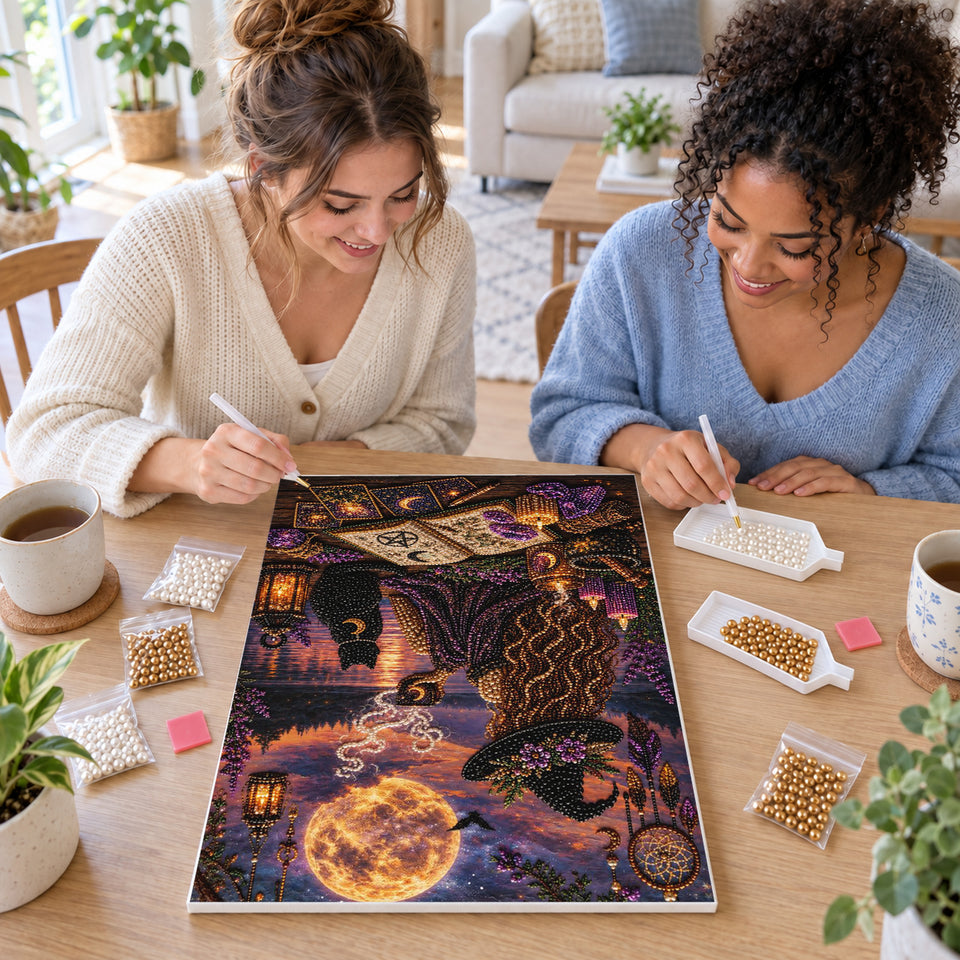 Two friends creating one shared Pearl artwork — Moonlit Witch with a Black Cat by the Lake. Pearl diamond painting DIY kit by Isuvio.