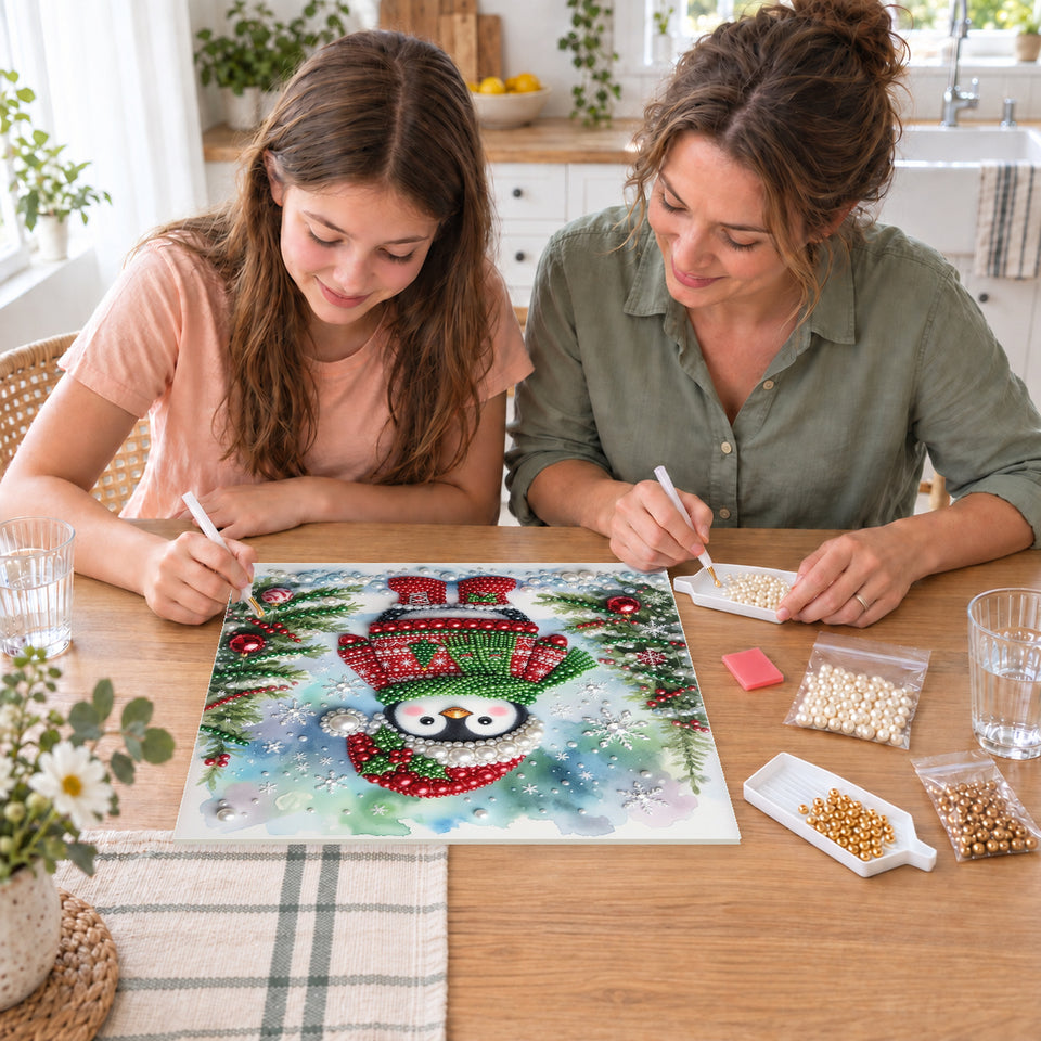Mother and daughter creating one shared Pearl artwork — Snowy Penguin in a Christmas Sweater. Pearl diamond painting DIY kit by Isuvio.