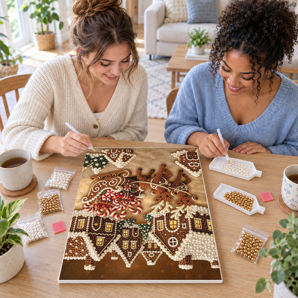Two friends creating one shared Pearl artwork — Gingerbread Village and Reindeer Sleigh. Pearl diamond painting DIY kit by Isuvio.