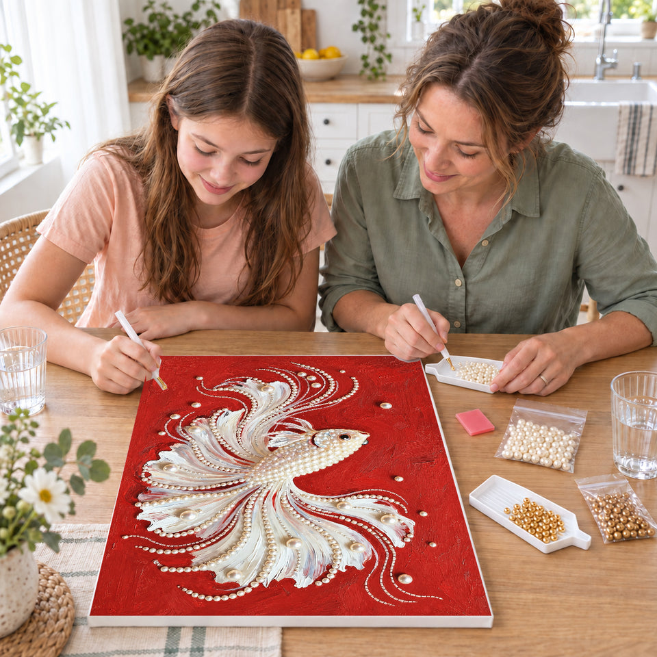 Mother and daughter creating one shared Pearl artwork — White Pearl Betta on Red. Pearl diamond painting DIY kit by Isuvio.