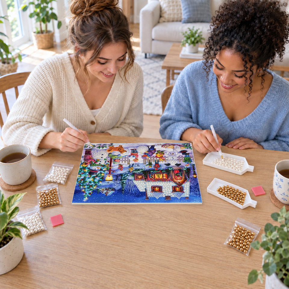 Two friends creating one shared Pearl artwork — Children Building Snowmen in a Christmas Village. Pearl diamond painting DIY kit by Isuvio.