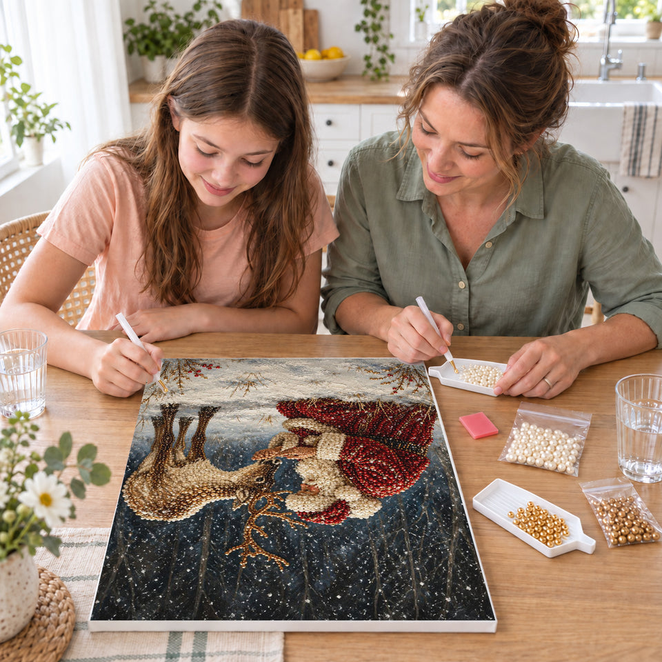 Mother and daughter creating one shared Pearl artwork — Santa Feeding a Reindeer in the Snowy Forest. Pearl diamond painting DIY kit by Isuvio.