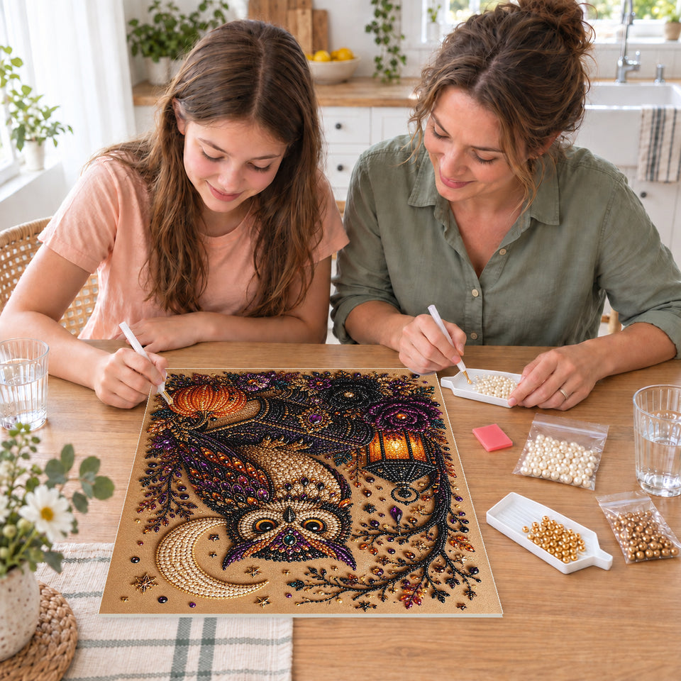 Mother and daughter creating one shared Pearl artwork — Jeweled Owl on Spell Books Beside a Lantern. Pearl diamond painting DIY kit by Isuvio.