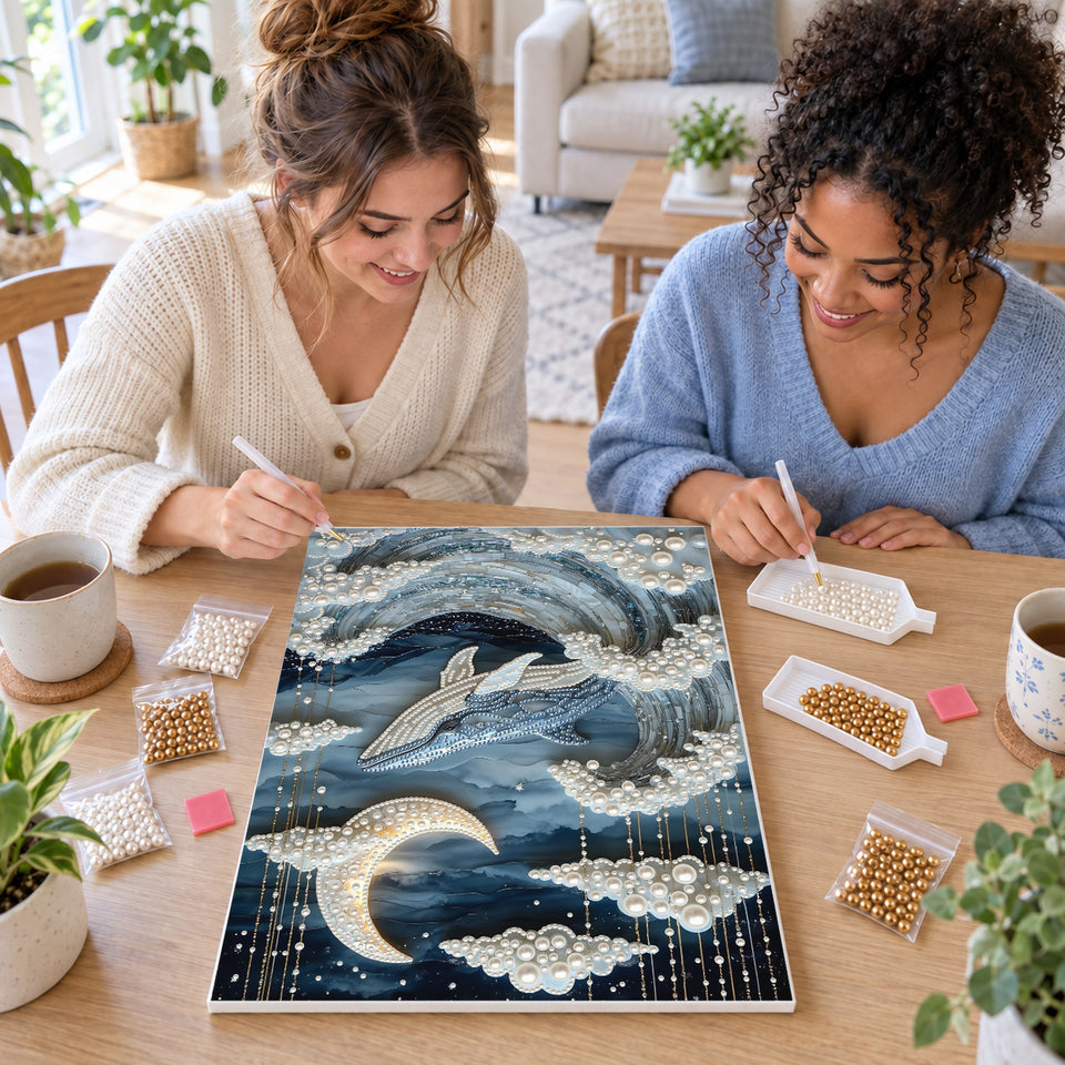 Two friends creating one shared Pearl artwork — Whale Rising Through Moonlit Pearl Waves. Pearl diamond painting DIY kit by Isuvio.