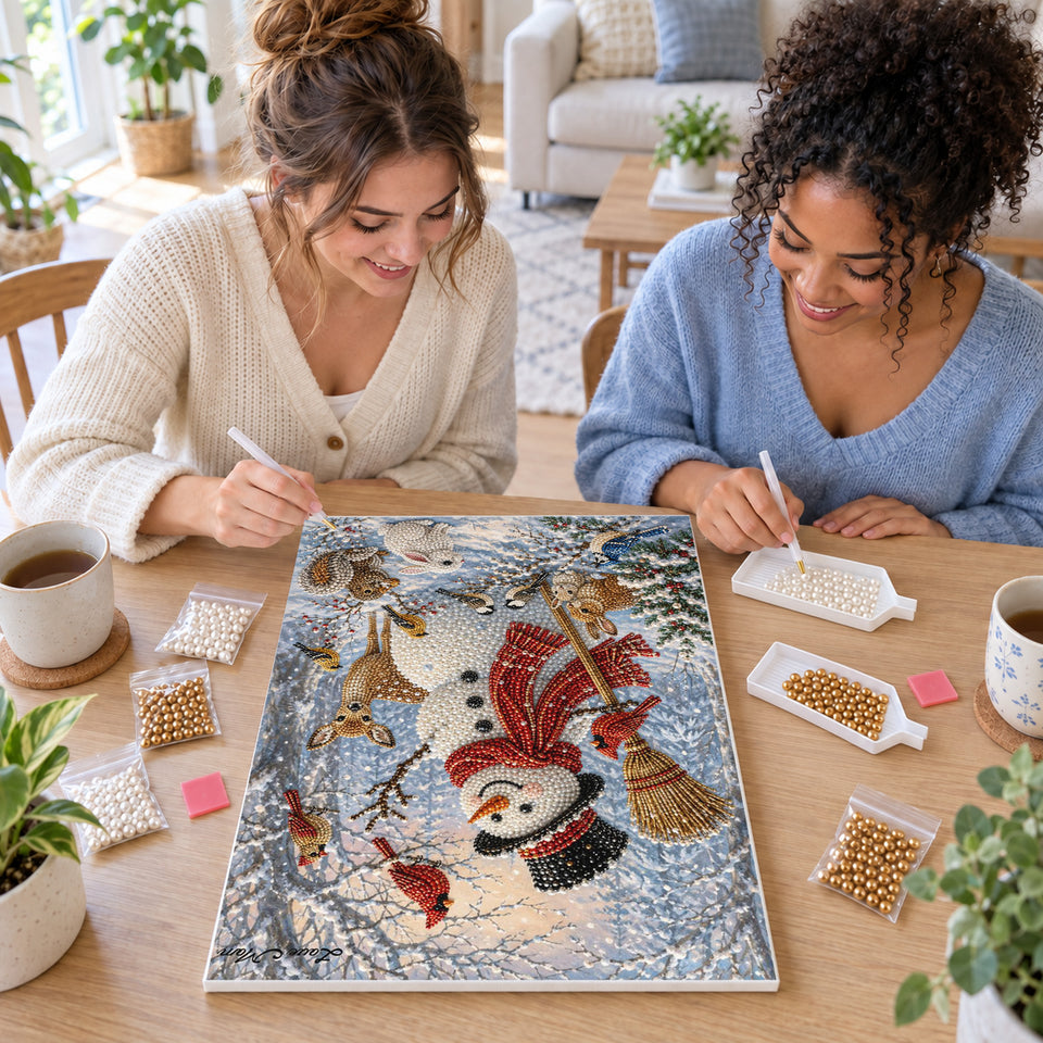 Two friends creating one shared Pearl artwork — Woodland Snowman with Cardinals and Forest Friends. Pearl diamond painting DIY kit by Isuvio.
