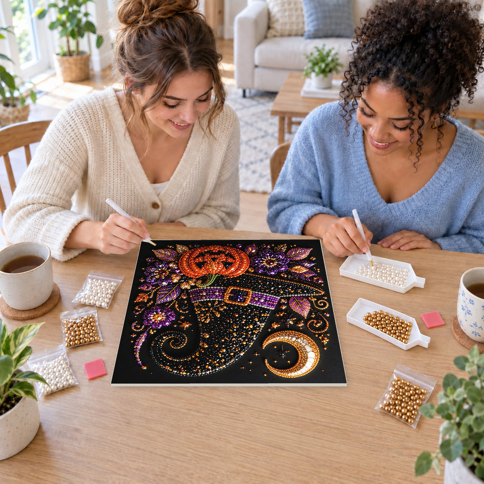 Two friends creating one shared Pearl artwork — Purple-Banded Witch Hat with a Pumpkin. Pearl diamond painting DIY kit by Isuvio.