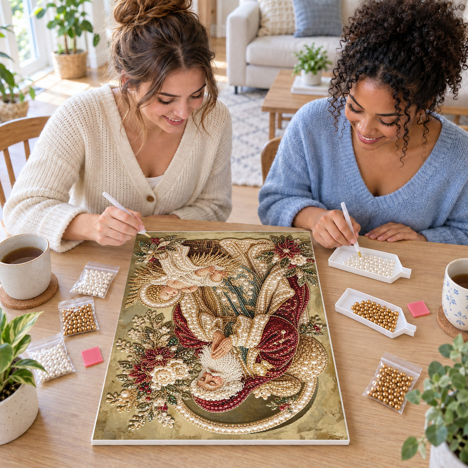 Two friends creating one shared Pearl artwork — Santa Kneeling at the Manger. Pearl diamond painting DIY kit by Isuvio.