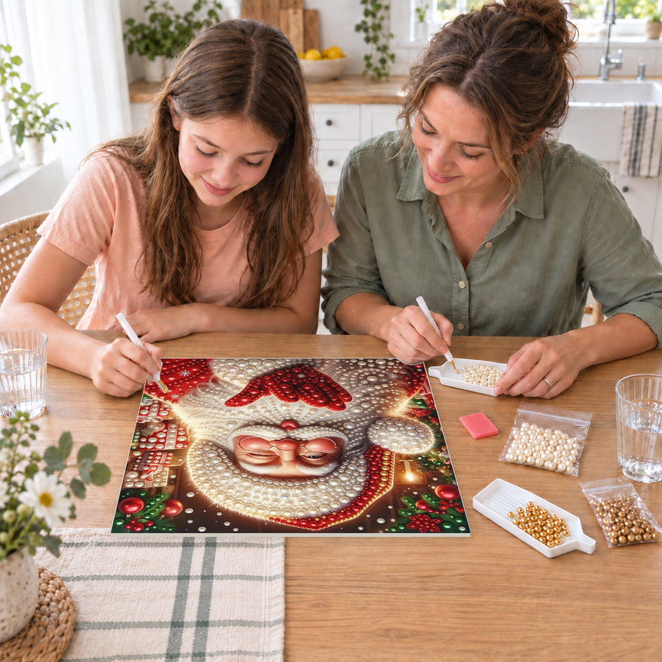 Mother and daughter creating one shared Pearl artwork — Santa Blowing a Christmas Kiss. Pearl diamond painting DIY kit by Isuvio.