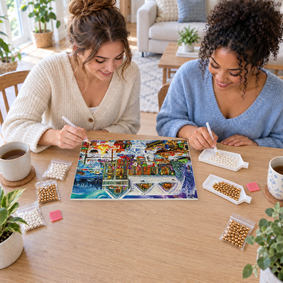 Two friends creating one shared Pearl artwork — Snowy Christmas Market Village. Pearl diamond painting DIY kit by Isuvio.