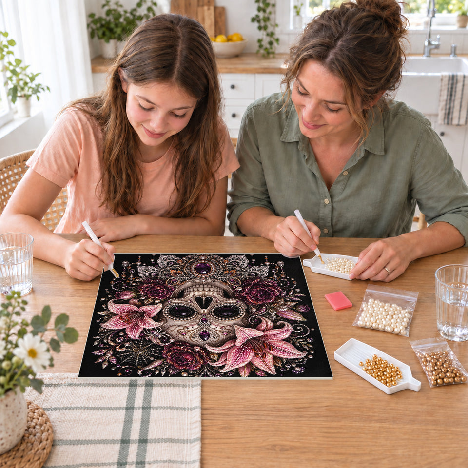 Mother and daughter creating one shared Pearl artwork — Ornate Skull with Pink Lilies and Purple Jewels. Pearl diamond painting DIY kit by Isuvio.
