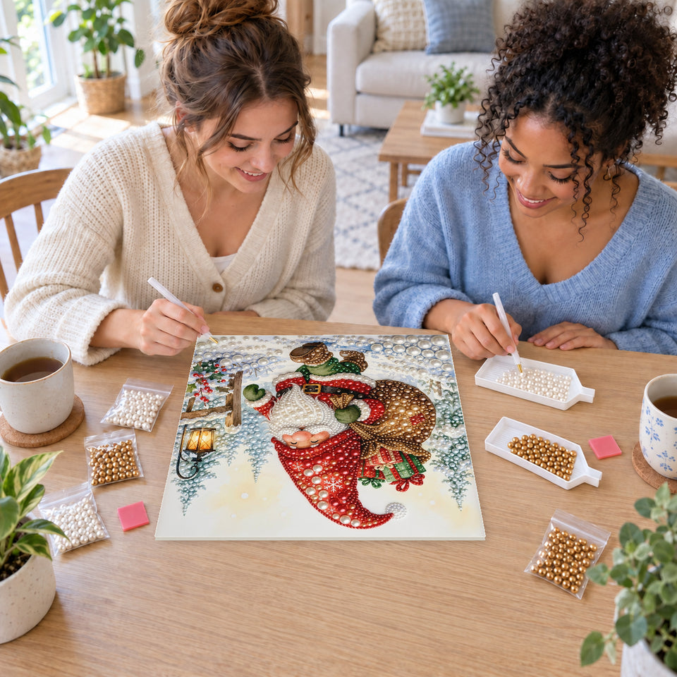 Two friends creating one shared Pearl artwork — Christmas Gnome Carrying Gifts through the Snow. Pearl diamond painting DIY kit by Isuvio.