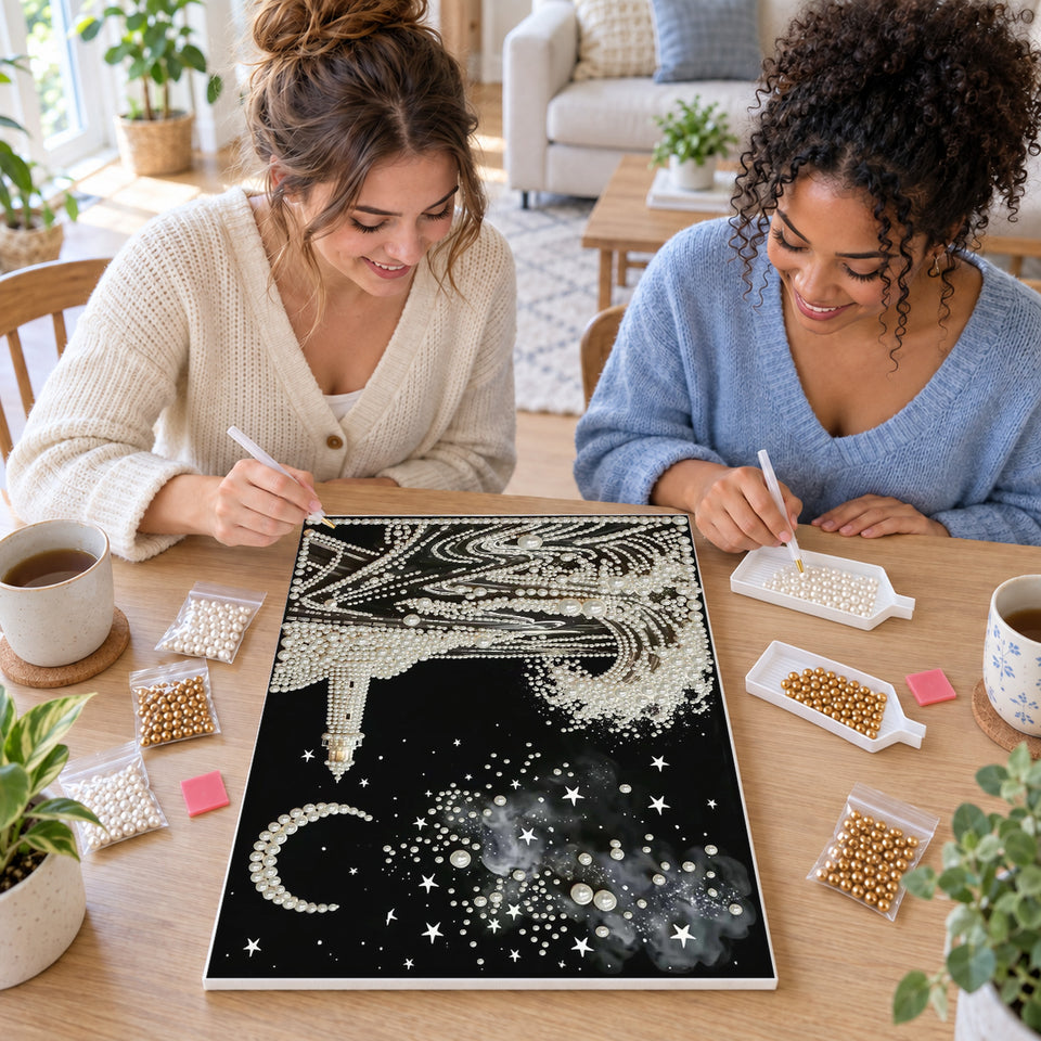 Two friends creating one shared Pearl artwork — Pearl Lighthouse Beneath a Crescent Moon. Pearl diamond painting DIY kit by Isuvio.