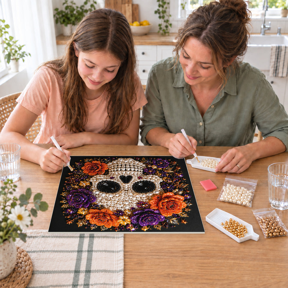 Mother and daughter creating one shared Pearl artwork — White Skull with Purple and Orange Roses. Pearl diamond painting DIY kit by Isuvio.