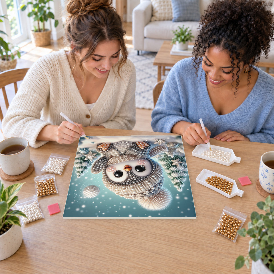 Two friends creating one shared Pearl artwork — Baby Penguin in a Snowy Forest. Pearl diamond painting DIY kit by Isuvio.
