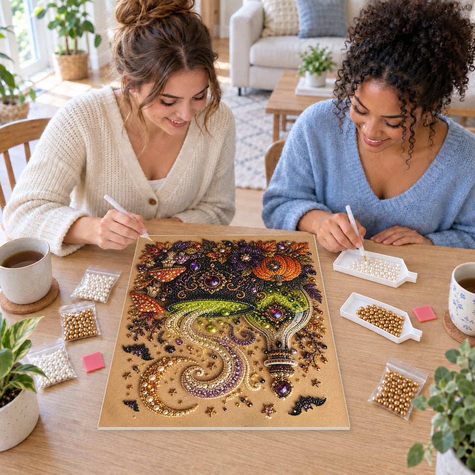 Two friends creating one shared Pearl artwork — Green Potion Cauldron with Mushrooms and Pumpkins. Pearl diamond painting DIY kit by Isuvio.