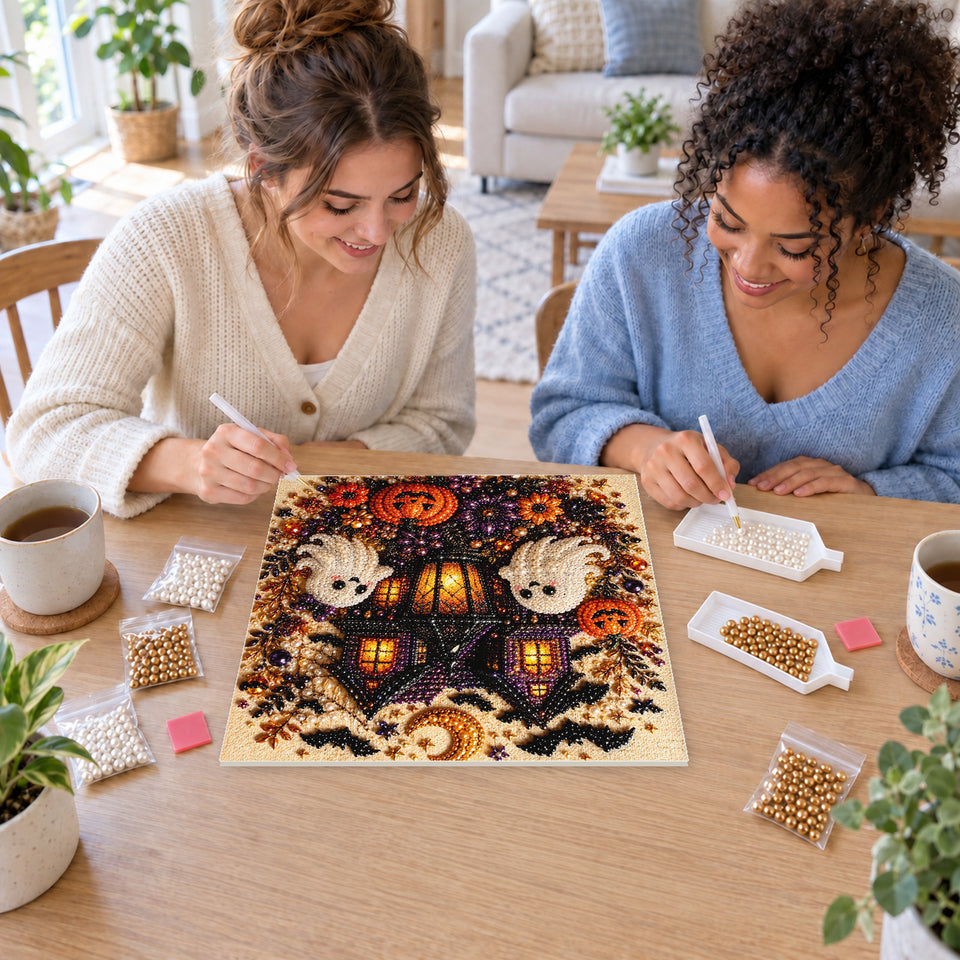 Two friends creating one shared Pearl artwork — Haunted House with Friendly Ghosts and Pumpkins. Pearl diamond painting DIY kit by Isuvio.