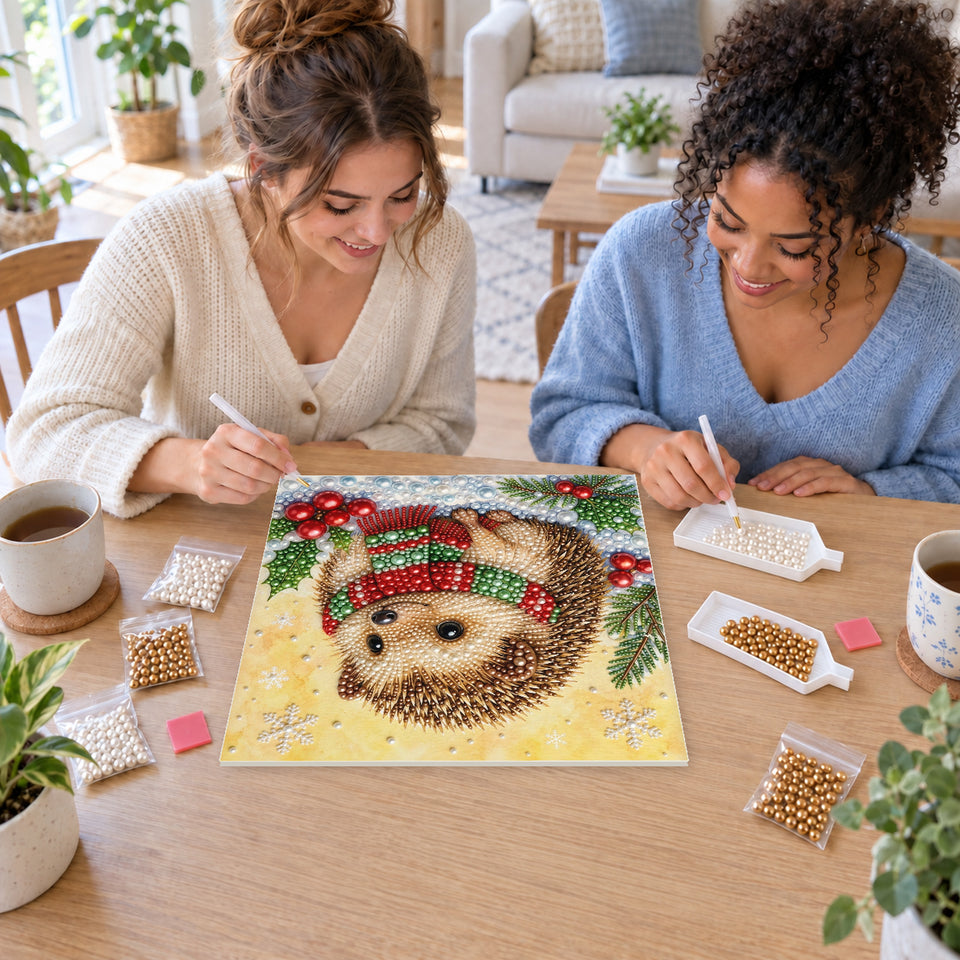 Two friends creating one shared Pearl artwork — Little Hedgehog in Snowy Holly. Pearl diamond painting DIY kit by Isuvio.