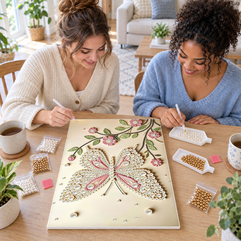 Two friends creating one shared Pearl artwork — Pink and White Butterfly Above Flowering Branches. Pearl diamond painting DIY kit by Isuvio.