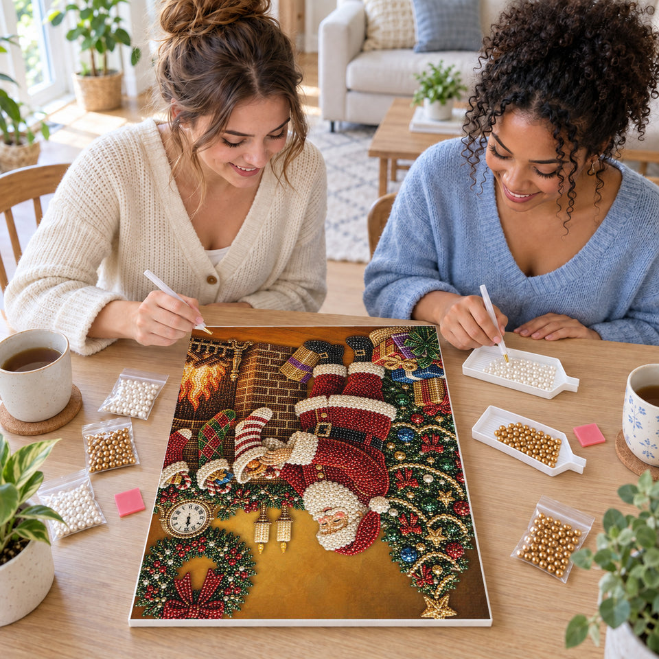 Two friends creating one shared Pearl artwork — Santa Filling Stockings Beside the Fireplace. Pearl diamond painting DIY kit by Isuvio.
