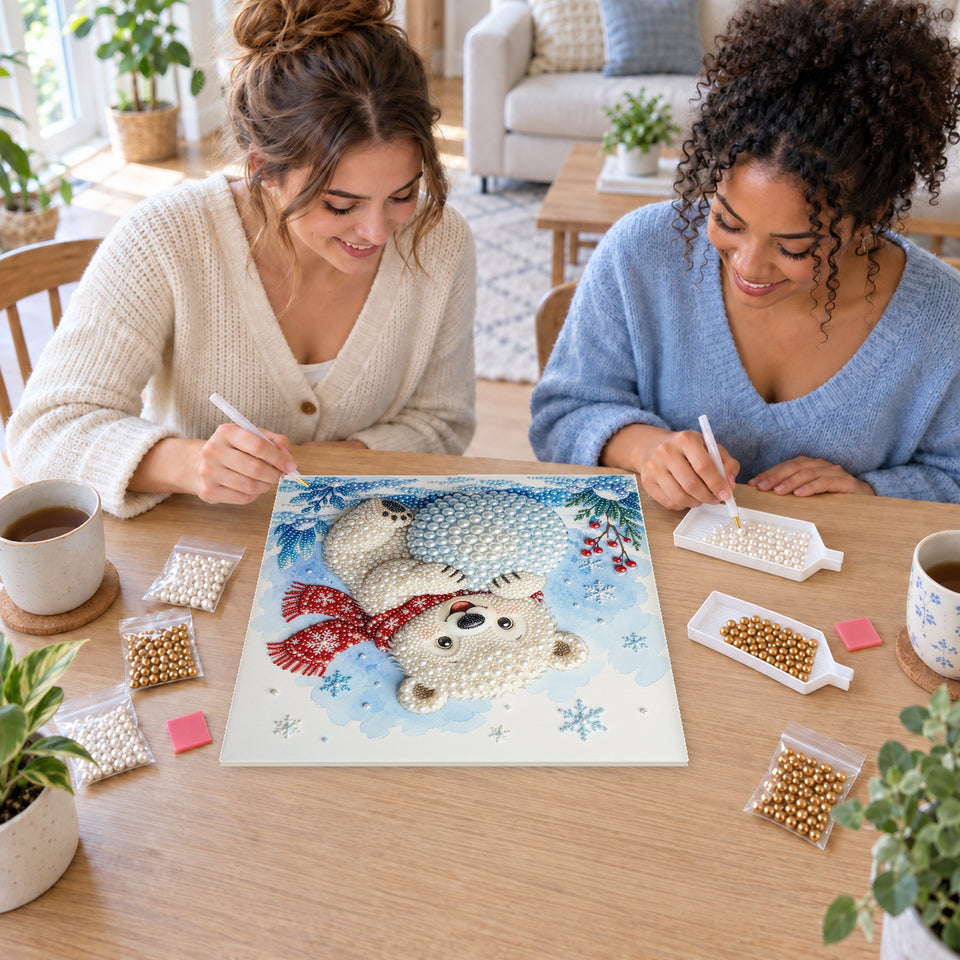 Two friends creating one shared Pearl artwork — Polar Bear Cub Hugging a Snowball. Pearl diamond painting DIY kit by Isuvio.