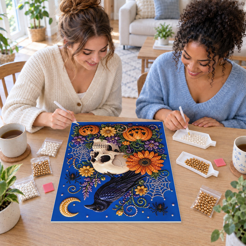 Two friends creating one shared Pearl artwork — Raven on a Skull with Autumn Flowers. Pearl diamond painting DIY kit by Isuvio.
